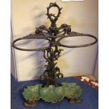 A Victorian cast iron stick stand with two oval stick supports and foliate stem on shell base with