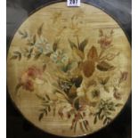 A framed silkwork floral study, circular, 35cm in diameter (af)