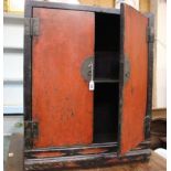 A Chinese red and black lacquer cabinet 90cm high, 75cm wide