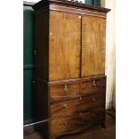 A 19th Century mahogany cupboard with two short and one long false drawer and a further true