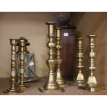 Three pairs of brass candlesticks, a candle box and a lantern