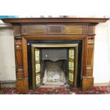 A Victorian fire plate, with tile surround and a mahogany mantelpiece and fender 135cm high, 180cm