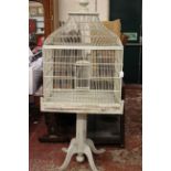 A cream painted birdcage on stand 170cm high, 70cm wide