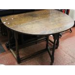 An 18th Century oak gateleg table with a frieze drawer to either end 129cm extended