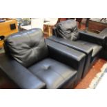 Three modern black leather armchairs