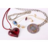 A Lalique heart pendant on red robe twist chain, a Cada pendant on chain, a gold pendant on chain,