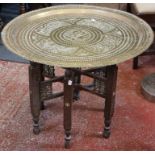 A brass Benares tray on stand and a brass tray, 76cm high