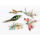 A silver and enamel leaf brooch, a silver and enamel dragonfly brooch, two other enamel brooches and