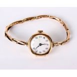 A 9ct gold ladies wristwatch, enamel dial (af), 15.7g in total