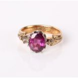 An 18ct gold ring set with purple coloured stone, 4.8g in total (af)