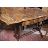 An oyster veneered drop leaf table with two drawers on lyre supports 72cm high, 134cm wide