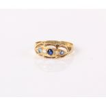 An 18ct gold and five stone ring inset with two small diamonds and sapphire coloured stones, 1.8g in