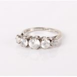 An 18ct white gold and five stone diamond ring, five graduated diamonds, 4.6g in total