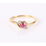 A gold ring with small central ruby flanked by two small diamonds, shank unmarked, 1.8g in total