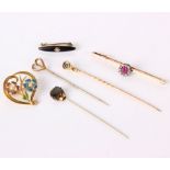 A 15ct gold floral brooch, four stick pins, a bar brooch and another brooch