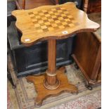 A Victorian games table with chequer board top raised on a single column