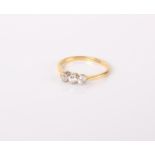 An 18ct gold and diamond three stone ring, 1.9g in total