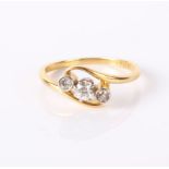 An 18ct gold and diamond three stone ring, 2.6g in total.