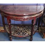 A Chinese hardwood demi lune side table with a pierced undertier 106cm wide