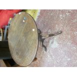 A George III oak tripod table on turned stem and splayed legs and pad feet 77cm diameter