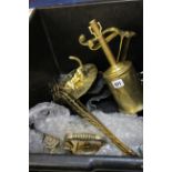 A brass desk pen and ink stand, a brass puppy dog sundial, brass toasting forks, spit turner, a pair