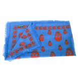 An Alexander McQueen skull print cotton scarf, blue background with red skulls