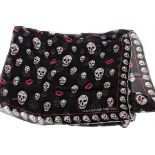 An Alexander McQueen skull print silk scarf, black background with white skulls and red lipstick