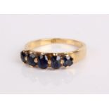 An 18ct gold and five stone sapphire ring, 4.8g in total