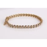 A 10ct gold and diamond tennis bracelet, 7.9g in total