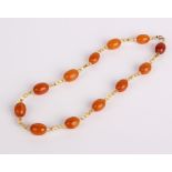 A butterscotch amber and yellow beaded necklace (twelve amber beads) 24.4g in total