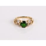 A 14ct gold diopside ring, 4.3g and a pair of diopside earrings