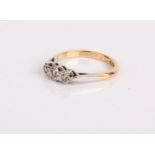 An 18ct gold and diamond three stone ring, 2.9g in total