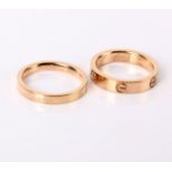 An 18ct gold wedding band, inscribed Cartier and 750, 2.2g and another 'Love' ring inscribed Love