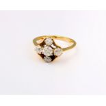 An 18ct gold and diamond five stone ring, the central diamond 5mm approx. in diameter two diamonds