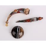 A gold coloured mosaic kilt pin, another mosaic pin and an agate brooch (3)