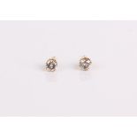 A pair of 14ct gold and diamond solitaire earrings, each 4mm in diameter approx.