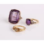 A gold and amethyst dress ring, another amethyst ring and a gold coloured ring (3)