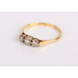 An 18ct gold and diamond three stone ring, 1.9g in total