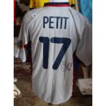 A Barcelona football shirt, with signature Emmanuel Petit