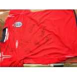 An Umbro red England shirt signed by seventeen members of the 2004 England squad