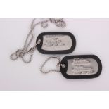 Two silver and black dog tags from 'Charlie's Angels'