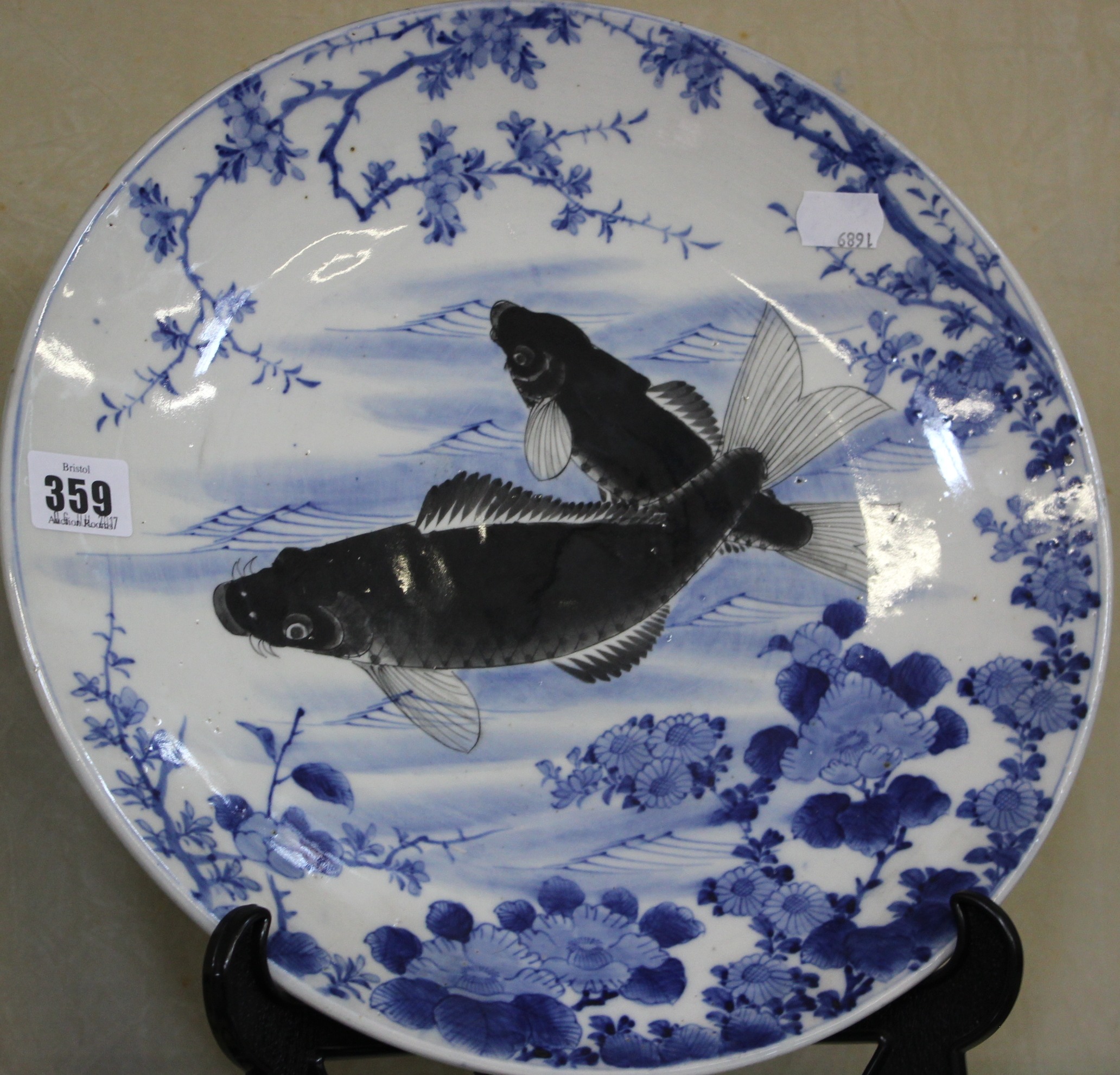 A Chinese blue and white charger, decorated with carp, 32cm in diameter