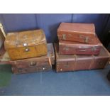A group of vintage luggage to include a trunk and three leather suitcases and a painted tin trunk