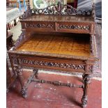 A 19th Century carved oak side table the two drawer superstructure on geometrically carved top