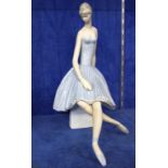 A Lladro figure of a seated ballerina, model no. 4559, 36cm high