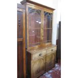 A 19th Century mahogany bookcase with arched glazed doors, two drawers and cupboard below 210cm