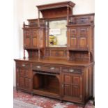 A Victorian walnut sideboard, the mirrored superstucture flanked by two pairs of panelled doors, the