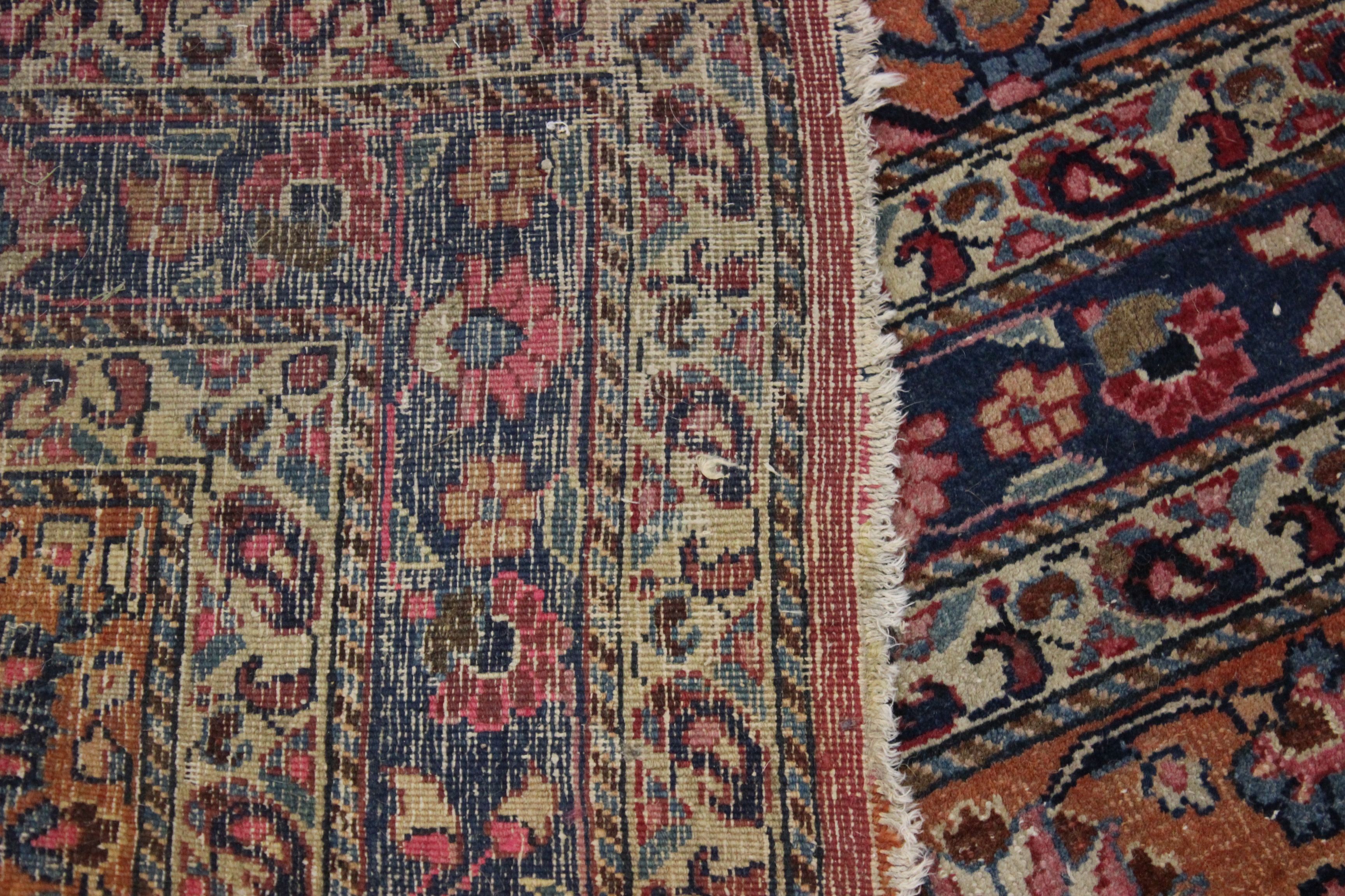 A Meshed carpet, the madder field with central indigo medallion within a floral border, bearing - Image 6 of 6