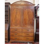 A Georgian mahogany and inlaid linen press, the cupboard above two short and three long drawers on