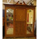 An Edwardian inlaid mahogany wardrobe, with a pair of mirrored doors 228cm high, 228cm wide and a